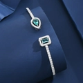 Macro view of adjustable open bangle with pear and rectangle green stones and pavé diamonds - Sky Blue