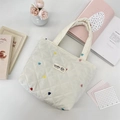 Detail of quilted canvas tote with colorful heart embroidery and brand logo patch - Rainbow Gradient Heart