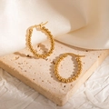 Close-up of 18k gold plated beaded hoop earrings on elegant beige stone backdrop - Vintage Simple Beaded Hoop