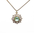 Golden sunburst necklace featuring a green center stone and rectangle zircon petals - Green