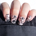 Short square nude pink press-on nails with black floral pattern on hand model - Black Flower Style - Glue Type (Y-377)