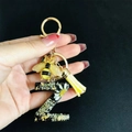 Detail of resin letter Z keychain featuring real dried white flowers and gold foil flakes - Letter Z