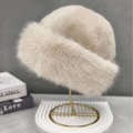 Detail of plush beige faux fur winter hat with thick texture and warm dome design - One Size / Off White