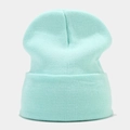 Close-up of mint green knitted beanie showing premium ribbed texture and folded cuff detail - Aqua