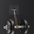 Transparent flower-shaped adhesive hook holding a heavy dumbbell to show strong load capacity - 60 Silk Transparent Acrylic Hook