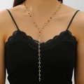 Detail of a gold Y-shaped necklace featuring colorful heart-shaped links on a model - Gold Multicolor Heart Y Necklace (DZ-841)