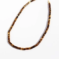 Tiger eye stone beaded necklace with golden spacers and cylinder beads on white background - Tiger's Eye