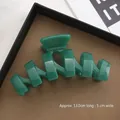 Deep green 13cm large acrylic shark clip for thick hair, shown in a brown display tray - 13CM Large N-Shape / Malachite green