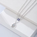 Detail of s925 silver double necklace featuring Evil Eye and Hamsa Hand charms with blue stones - 925 Silver / White