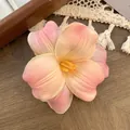 Pink and yellow gradient tulip flower hair clip on a vintage wooden background - Orange Pink Gradient