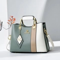 Elegant color-block tote bag with metal handles and butterfly charm in green and white - Green/White