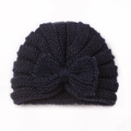 Detail of navy blue baby knitted beanie featuring a large bow and warm ripple texture - Navy Blue