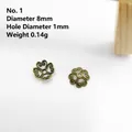 Detail of 8mm antique bronze alloy flower bead caps with hollow filigree pattern - Style 1