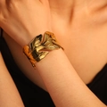 Elegant gold open cuff bracelet with detailed hollow leaf design and polished maple vein texture - Maple Leaf