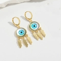 Detailed close-up of gold Evil Eye earrings with teal eye center and three feather charms - Blue