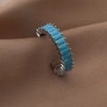 Close-up of minimalist silver open ring with turquoise baguette stones on brown silk - Adjustable Open / Silver Blue Zirconia