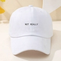 Detailed shot of white Y2K baseball cap featuring black Not Really letter embroidery - White