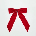 Detailed top view of a large red velvet ribbon bow clip with soft plush texture on white - Red