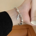 Detail of luxury pearl bracelet with silver beads and rectangular metal charm pendant - S534 Silver