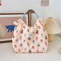 Close-up of embossed bubble texture fabric and cute cartoon animals on a cream tote bag - Beige Doll
