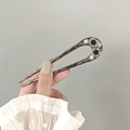 Detail of vintage U-shaped hair stick with black flowers and pearls held by hand - U-shaped Branch Flower