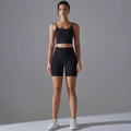 Full view of women's black high-waisted yoga set with crop top and cycling shorts - S / Black