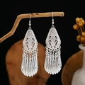 Detail of silver ethnic drop earrings featuring hollow leaf carving and long tassel accents - Silver Fine Hollow Tassel Style (E2873-4)