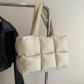 Minimalist beige quilted puffer tote bag hanging on a rack with long shoulder straps - Khaki