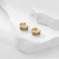 Detail of luxury gold hoop earrings with green zircon pave on minimalist white stone base - White and Green Zirconia
