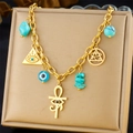 Detailed view of a gold plated necklace with turquoise beads and ancient eye charms - Egyptian Turquoise Horus Eye Style (N3265)