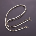 Detail of white faux pearl and gold metal chain strap with black ribbon and camellia charm - Black Leather Woven Double Chain Camellia