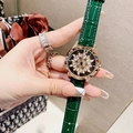 Macro view of green leather watch strap and golden floral dial with diamond accents - Rose Gold Green Leather Strap