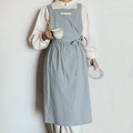 Light blue cotton apron with tie-back design and a small decorative chest label - Light Blue