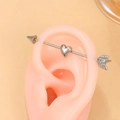 Close-up of silver punk heart and arrow industrial barbell piercing on an ear model - Silver Arrow Heart Stainless Steel (DZ-1053)