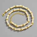 Close-up of golden bone-shaped chain links with crystal pavé and lobster clasp detail - Necklace-18inch(45cm) / Gold