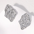 Orecchini moderni in acciaio inossidabile argento con trama geometrica su marmo - Color Acciaio