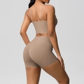 Detail view of the khaki ribbed yoga set featuring a backless bra and high waist shorts - Mocha Brown