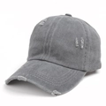 Detailed macro view of gray washed cotton baseball cap featuring vintage distressed holes - Dark Gray