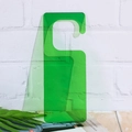 Single translucent green acrylic hanging tag on a white brick wall background - Emerald Green (Transparent)