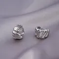 Elegant chunky ribbed silver hoop earrings resting on soft purple satin fabric - E-090---Platinum