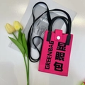 Close-up of pink knitted phone bag with Greenbag print and black crossbody strap - Greenbag-Pink