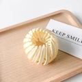 Beige bird nest hair clip expander for elegant buns on a minimalist wooden tray - Glossy Off-White