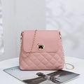 Pink quilted crossbody handbag with heart-shaped gold clasp and elegant chain strap - Pink