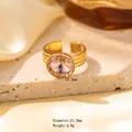 Gold plated titanium steel ring with a large pink crystal inlay on a stone tray - Adjustable Open / Gold with Round Pink Gemstone (JOM25007)