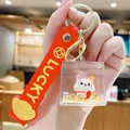 Lucky cat keychain with red silicone strap and gold glitter in a square acrylic case - New Year Lucky Cat - Abundance / Individual Packaging