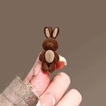 Cute dark brown flocked rabbit hair clip held in hand to show the miniature size - Rabbit