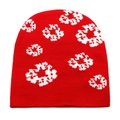 Detailed view of the red knit beanie with white jacquard floral patterns and texture - M(54-60cm) / Red