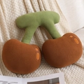 Brown cherry plush pillow in U-shape design on beige knit blanket for cozy nap - Brown