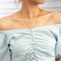Detailed view of triple-layered gold heart pendant necklace on a model's neck - Gold Double Heart (NZ1279)