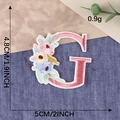 Pink letter G embroidery patch with colorful floral accents for clothing decoration - Letter G / Hot Melt Adhesive